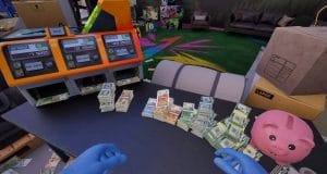 Machine de comptage de billets et tirelire rose.