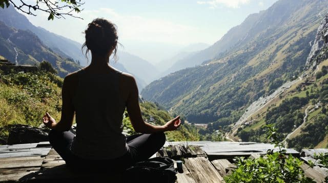 ecdeb5a0 c988 4e9a 9e11 b696557d77d1 0 Woman meditating in mountains