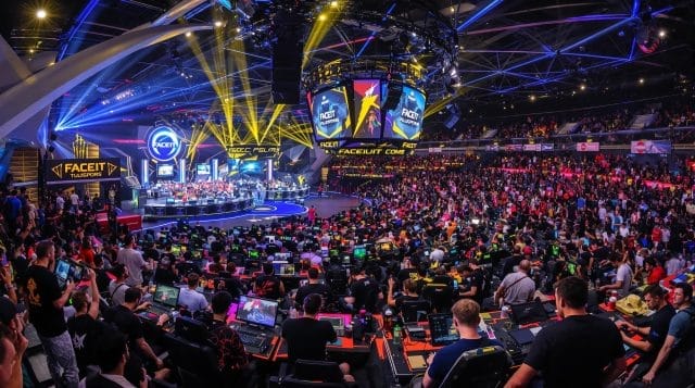 Full view of a large esports tournament arena with a packed audience.