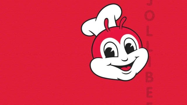 jollibee bouleverse le jeu : découvrez sa campagne audacieuse ! Mascotte rouge et blanche souriante avec toque.