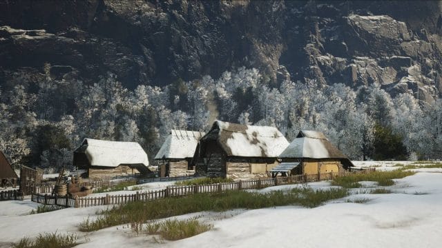 manor lords : découvrez les surprises d'une année de succès Village enneigé avec montagnes en arrière-plan.