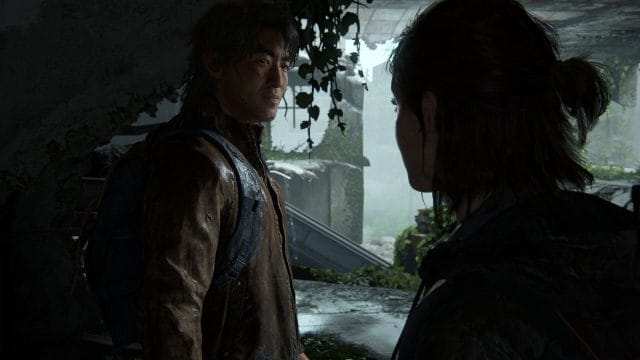 mise à jour 1.3 de the last of us part Deux personnages discutent dans un bâtiment abandonné.