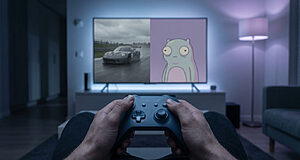 Hands gently hold gray game controller. TV shows split screen: racing car, faded cartoon. Dim, cool-toned room, quiet disappointment.