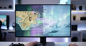 Gaming monitor displaying a split screen of Carto and Spirit of the North scenes, both glitching into static. Hands hold a controller.