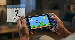 Close-up of hands playing a handheld gaming console with a pixel-art game. A '7 DAYS' countdown and a dollar sign icon are visible.