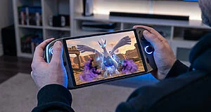 Un joueur tient une console portable affichant Lugia de Pokémon XD au milieu d'un combat dans un décor désertique.