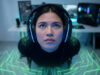 Une joueuse concentrée portant un casque gaming avec des ondes sonores numériques vertes autour d'elle.