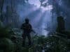 Ghost recon wildlands last rites : le choc 4K/60 FPS est là Un soldat lourdement armé dans une jungle dense avec des ruines antiques et une cascade en arrière-plan.