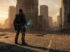 Agent de The Division Resurgence debout au milieu d'une rue en ruines à New York sous une lumière dorée.