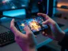 Quel smartphone gaming pas cher choisir en 2026 ? Gros plan sur des mains tenant un smartphone affichant un jeu d'action intense dans une chambre gaming éclairée en bleu.