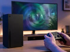Jeux gratuits xbox week-end : cinq titres à découvrir Console Xbox Series X posée sur une table avec une personne jouant sur un écran affichant un jeu en version bêta.