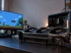 Une RTX 5090 fondue en jouant au pixel art, garantie refusée Carte graphique RTX 5090 gravement brûlée au niveau du connecteur d'alimentation posée sur un bureau devant un écran.