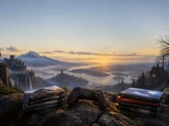 Neuf nouveaux jeux PS Plus Extra et Premium en octobre 2026 Manette de jeu et piles de jeux vidéo posées sur un rocher devant un paysage montagneux fantastique au coucher du soleil.