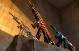 Trois fusils Valorant aux designs détaillés posés sur un bloc de pierre sous un éclairage dramatique.