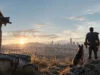 Un survivant et son chien regardent un paysage post-apocalyptique au coucher du soleil dans Fallout 4.