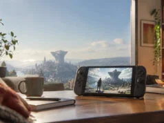 Démo gratuite de Metaphor : ReFantazio sur la Switch 2 et transfert vers le jeu Console portable affichant le jeu Metaphor: ReFantazio sur une table devant une vue panoramique d'une cité fantastique.