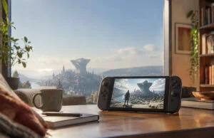Démo gratuite de Metaphor : ReFantazio sur la Switch 2 et transfert vers le jeu Console portable affichant le jeu Metaphor: ReFantazio sur une table devant une vue panoramique d'une cité fantastique.